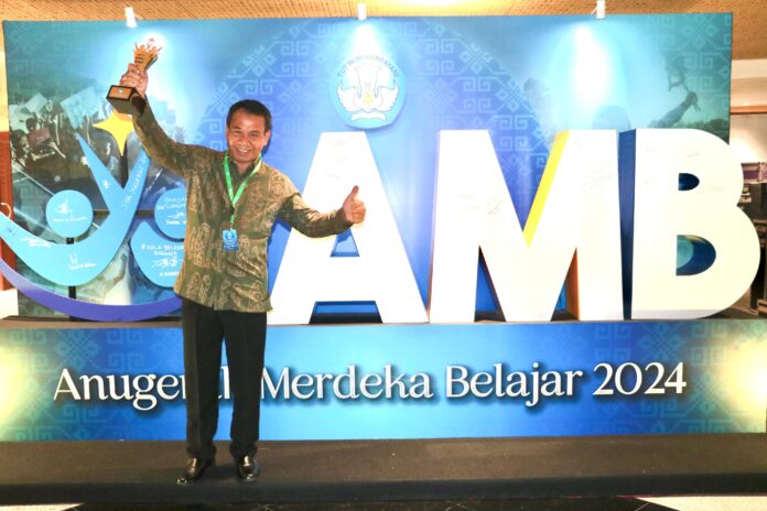 Pj Bupati Buleleng Ketut Lihadnyana saat menunjukkan piala anugerah merdeka belajar yang diberikan Kementerian Pendidikan, Kebudayaan, Riset dan Teknologi (Kemendikbudristek) RI dalam kategori Pemerintah Daerah (Pemda) Transformatif/Terbaik dalam Pengelolaan Program Indonesia Pintar (PIP)